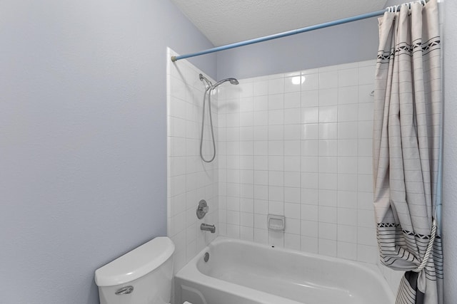 bathroom with shower / bath combo, toilet, and a textured ceiling