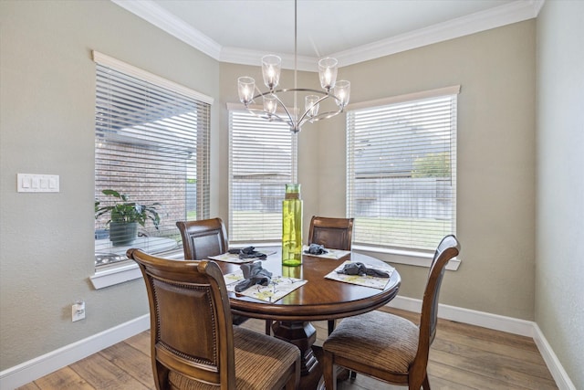 dining space with crown molding, light hardwood / wood-style floors, and a wealth of natural light