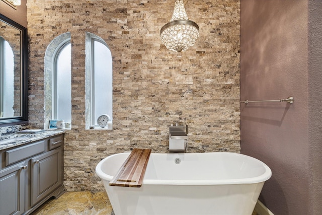 bathroom with vanity and a bath