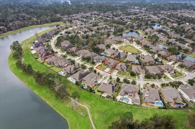 birds eye view of property with a water view