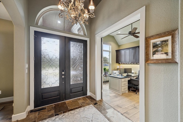 foyer with french doors, ceiling fan, lofted ceiling, and built in desk