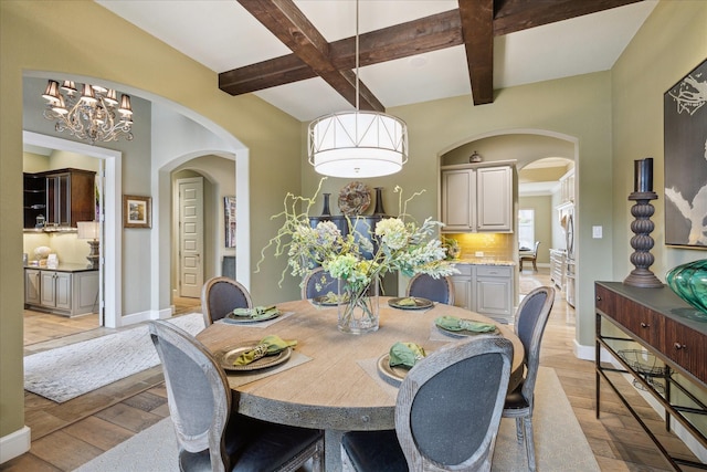 dining area with beamed ceiling, coffered ceiling, and light wood-type flooring