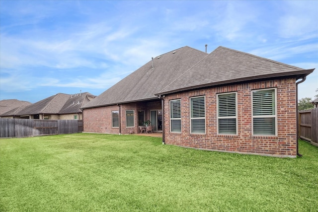 back of property featuring a lawn