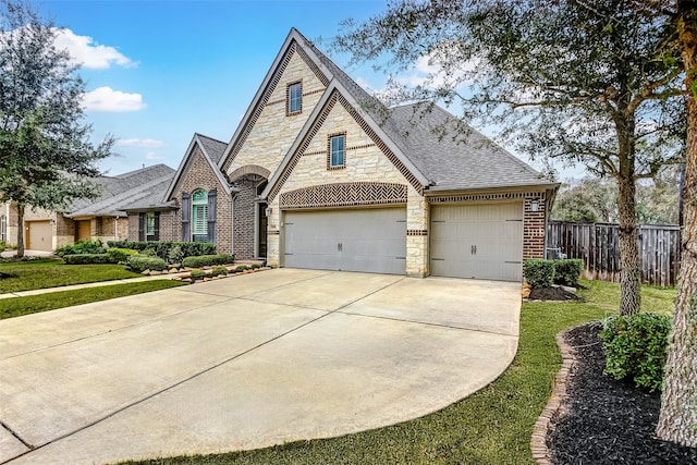 view of front of house with a garage and a front lawn