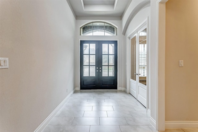 entrance foyer featuring french doors and light tile patterned floors