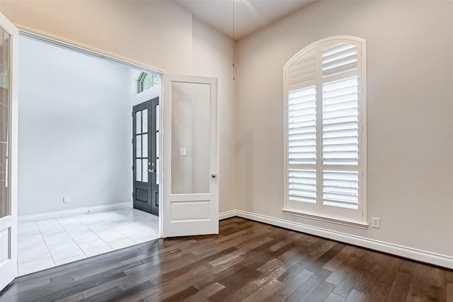 entryway with a wealth of natural light, french doors, and hardwood / wood-style floors