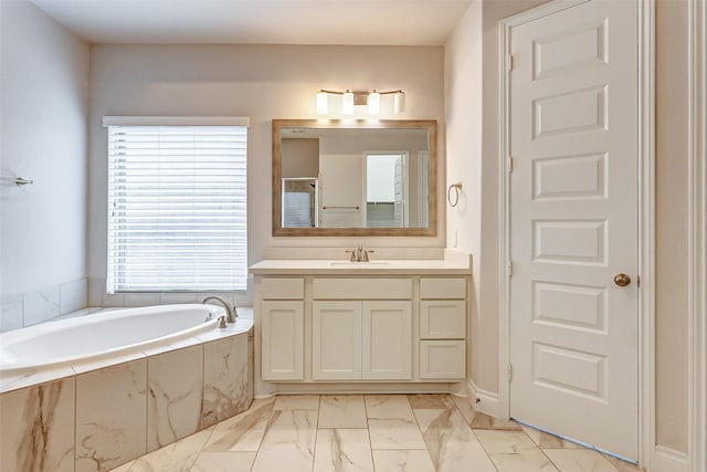 bathroom with vanity and tiled bath