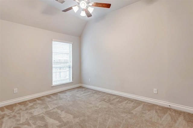 carpeted empty room featuring ceiling fan and lofted ceiling