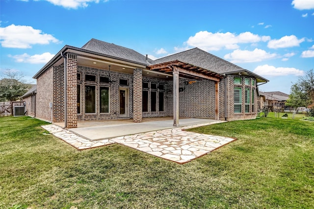 rear view of house with a lawn, central AC, and a patio