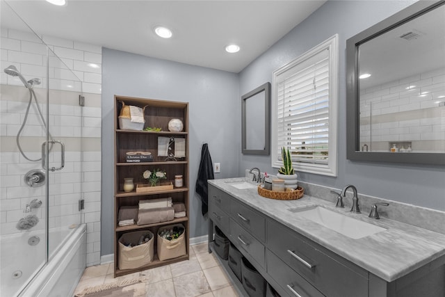 bathroom featuring tile patterned flooring, vanity, and bath / shower combo with glass door