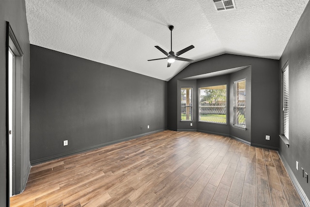 unfurnished bedroom featuring a textured ceiling, ceiling fan, and lofted ceiling