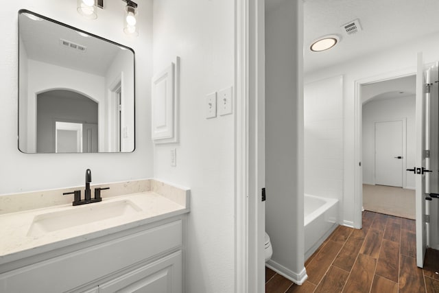 full bathroom featuring vanity, toilet, and  shower combination