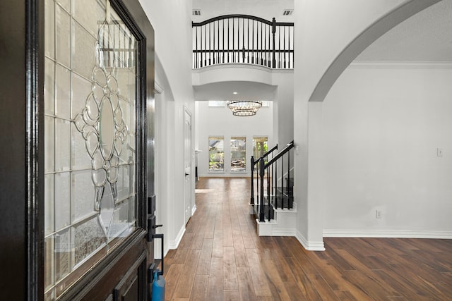 foyer featuring crown molding, french doors, a high ceiling, and dark hardwood / wood-style floors