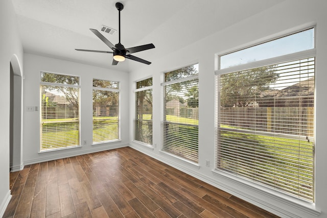 unfurnished sunroom featuring ceiling fan and vaulted ceiling