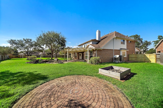 rear view of property featuring a lawn, a pergola, and a patio