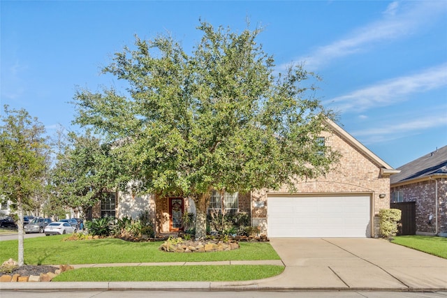 view of property hidden behind natural elements with a front lawn and a garage