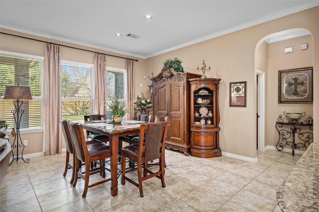 tiled dining space featuring crown molding