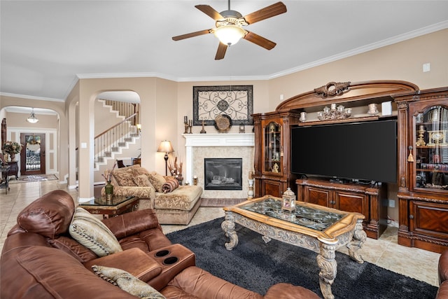 living room featuring ceiling fan, crown molding, and light tile patterned flooring