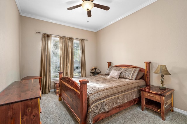 carpeted bedroom with ornamental molding and ceiling fan