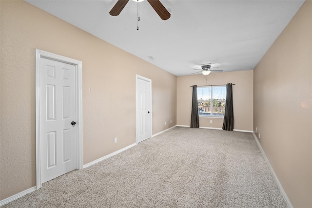 carpeted empty room with ceiling fan