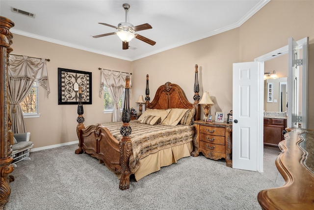 carpeted bedroom with ensuite bath, ceiling fan, multiple windows, and ornamental molding