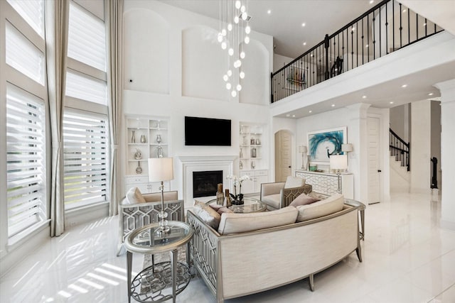 tiled living room featuring built in features and a high ceiling