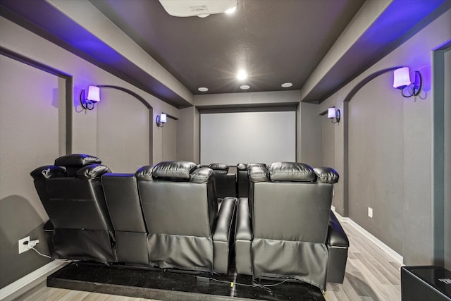 cinema room featuring light wood-type flooring