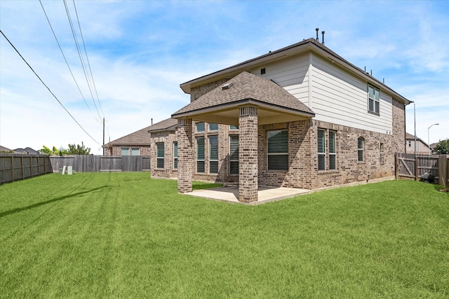 rear view of property with a patio area and a yard