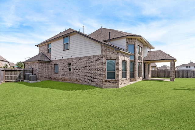 back of house with a patio area, a yard, and central AC unit