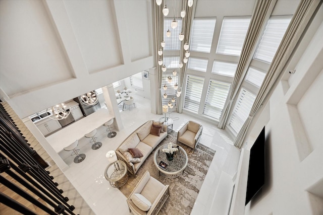 living room featuring a high ceiling and a chandelier