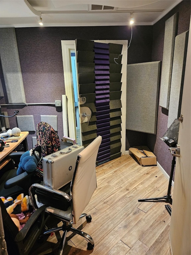 office space with track lighting and light hardwood / wood-style flooring