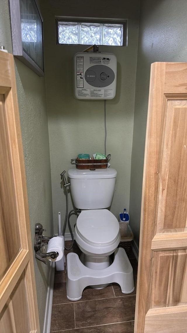 bathroom featuring a healthy amount of sunlight and toilet