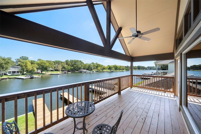 deck with ceiling fan and a water view