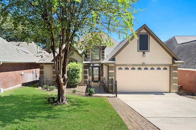 view of front facade with a garage and a front lawn