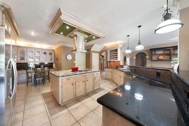 kitchen with sink, a center island, decorative light fixtures, appliances with stainless steel finishes, and ornamental molding