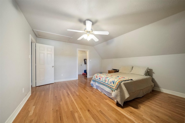 bedroom with ceiling fan, light wood-type flooring, and lofted ceiling