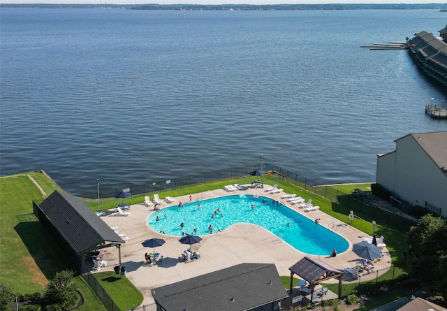 view of pool featuring a water view and a patio area