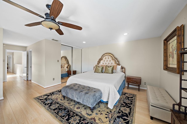 bedroom with ceiling fan, light wood-type flooring, and a closet