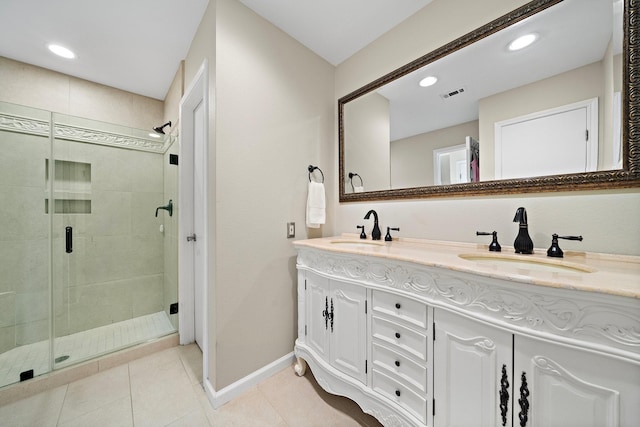 bathroom featuring tile patterned flooring, vanity, and a shower with shower door