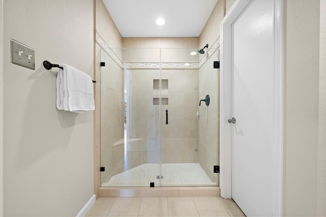 bathroom with tile patterned flooring and walk in shower