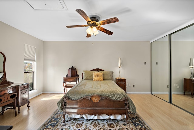 bedroom featuring ceiling fan, a closet, and light hardwood / wood-style flooring