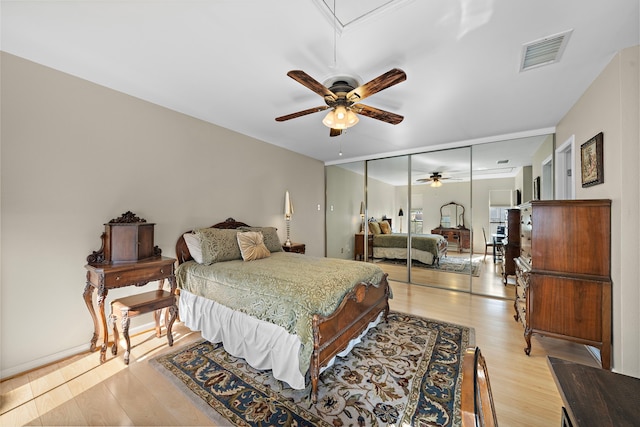 bedroom featuring light wood-type flooring, a closet, and ceiling fan