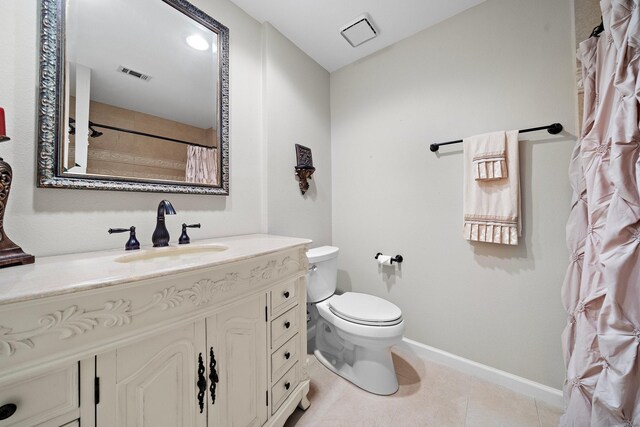 bathroom featuring tile patterned flooring, vanity, and toilet