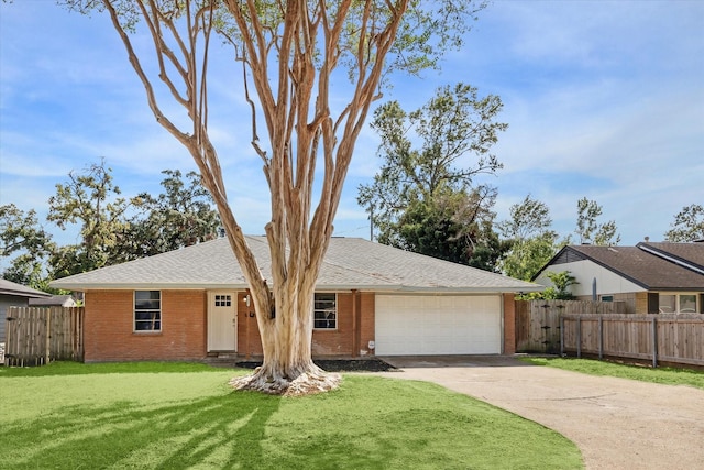 ranch-style house featuring a garage and a front yard