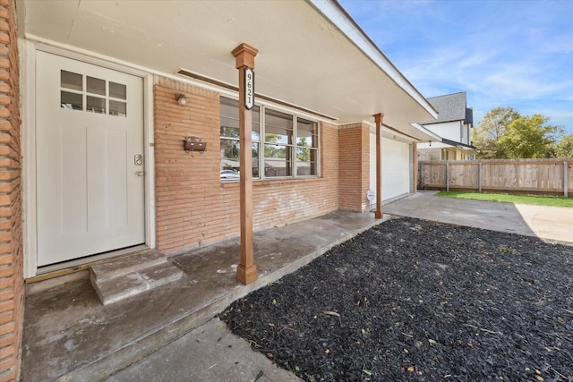 doorway to property with a garage