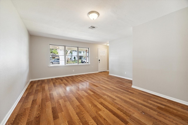 unfurnished room with wood-type flooring