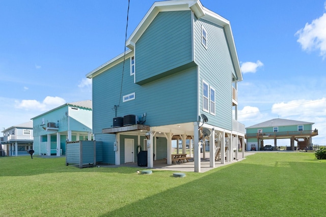 back of house featuring a yard, a patio, and central air condition unit