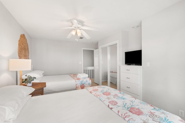 bedroom featuring ceiling fan and a closet