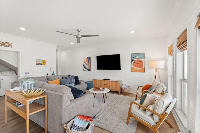 living room with washer / clothes dryer, ceiling fan, crown molding, and hardwood / wood-style flooring