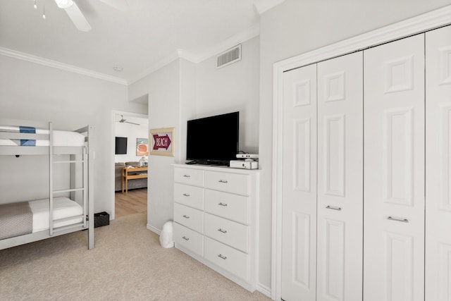 carpeted bedroom featuring ceiling fan and crown molding